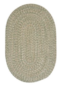 an oval rug with green and beige colors