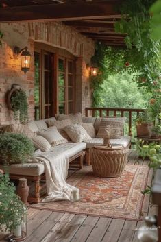 an outdoor living area with couches, tables and potted plants on the porch