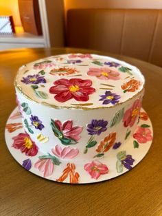 a decorated cake sitting on top of a wooden table