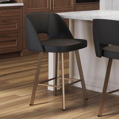 two black bar stools sitting on top of a wooden floor next to a counter