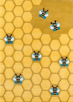 a yellow rug with bees and honeycombs on it