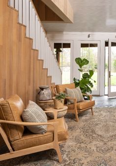 a living room filled with furniture and a stair case