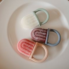 three different shaped objects on a white plate