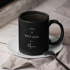 a black coffee mug sitting on top of a white plate