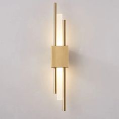 a wall light with two lights on each side and a rectangular tube in the middle