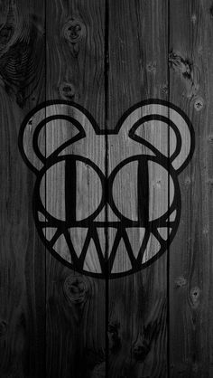 a black and white photo of a mickey mouse logo on wood planks with the letter d in it's center