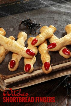 hot dogs with ketchup and mustard on top of an old book for halloween