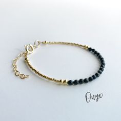 This beautiful black onyx gemstone bracelet is handcrafted with 4mm natural black onyx beads. The gold beading is done with high quality Japanese Miyuki Duracoat delica seed beads. The larger round gold beads are 14k gold filled for lasting quality. A 14k gold filled spring clasp completes the look. It's the perfect bracelet for layering or wearing all on its own! It's simple, yet elegant design makes it a great option for every day wear. This bracelet can be purchased in either 14k gold filled Black Beaded Dainty Jewelry, Everyday Spiritual Jewelry With Black Beads, Dainty Black Beaded Jewelry, Onyx Bracelet With Gemstone Beads, Onyx Gemstone Beads Bracelet Jewelry, Everyday Onyx Jewelry With Black Beads, Minimalist Onyx Beaded Jewelry, Minimalist Adjustable Jewelry With Black Beads, Black Beaded Bracelets With Gold Beads For Gifts