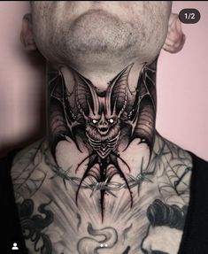 a man with tattoos on his neck has a bat tattoo on it's neck