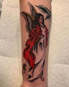 a tattoo on the arm of a woman with an angel holding a flower in her hand