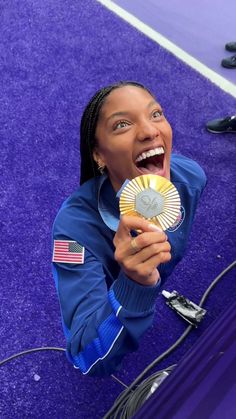 a woman holding a fan in her right hand and laughing while standing on the ground