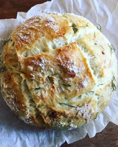 a round bread with some herbs on top of it