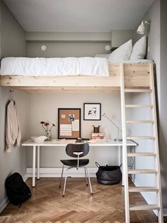 a loft bed with a desk underneath it