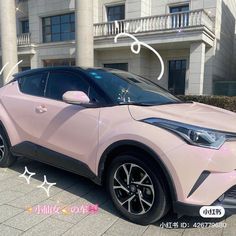 a pink car parked in front of a building