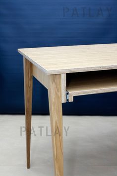 a wooden table with one drawer open on the bottom and two legs at the top