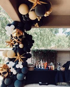 an outdoor bar decorated with balloons and starfishs