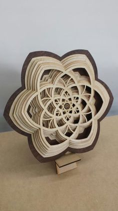 a sculpture made out of wood with an intricate design on it's center piece