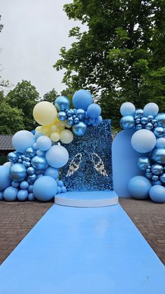 a blue and white wedding arch with balloons