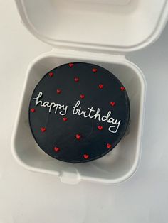 a happy birthday cake in a white container