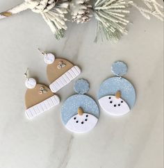 three decorated christmas ornaments sitting on top of a table