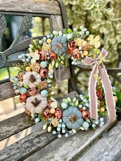 a wreath on a wooden bench with flowers