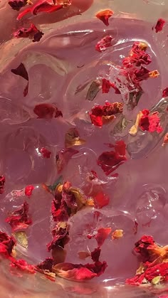 rose petals are floating in a bowl of water