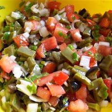 a yellow bowl filled with chopped up vegetables