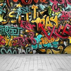 an empty room with graffiti written on the wall and brick floor in front of it