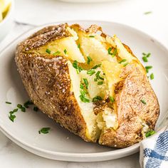 a baked potato sitting on top of a white plate