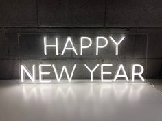 a neon sign that says happy new year