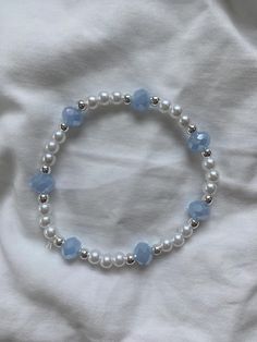 Pearl with light blue and silver accents, this beautiful bracelet makes for the perfect accessory for going out Blue And Silver Aesthetic, Light Blue Bracelet, Silver Pearl Bracelet, Manik Manik, Aesthetic Accessories, Wrist Stacks, Bracelets Ideas, Blue Beaded Bracelets, Diy Jewlery