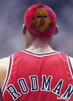 a man with a red wig and face paint on his head wearing a basketball uniform