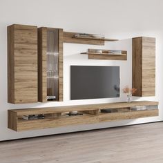 an entertainment center in a living room with white walls and wooden furniture, including a flat screen tv