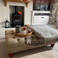 a living room with a couch, coffee table and fireplace in the backround