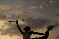 two people doing tricks in the air at sunset