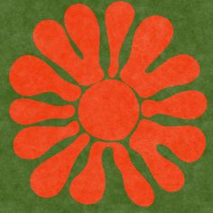 an orange flower on a green background with the center surrounded by smaller red flowers and leaves