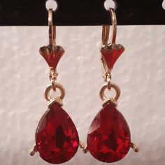 Small red oval crystals dangling on your ear as you go, this design is meant for the person that wants to go all out with a red dress. The pair hangs proportionately and bring more to emphasis to the face. Details Laminated gold Red oval crystal small design Red Drop Crystal Earrings As Gift, Elegant Red Drop Crystal Earrings, Red Teardrop Drop Earrings, Red Drop Jewelry With Matching Earrings, Red Teardrop Earrings For Formal Occasions, Red Drop Earrings For Formal Occasions, Red Ruby Drop Earrings, Red Ruby Drop Jewelry, Elegant Red Crystal Earrings