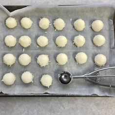 the dough balls are ready to be baked in the oven with a spatula next to them