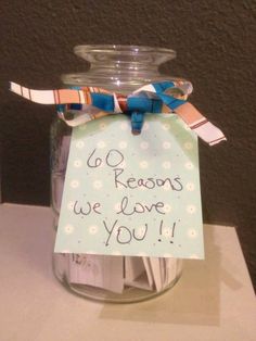 a glass jar with a note attached to it that says, do reason we love you