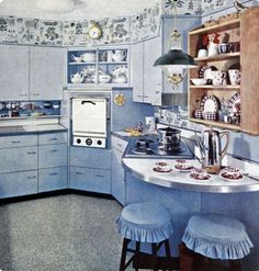 an old fashioned kitchen with blue and white decor