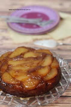 a dessert on a glass plate sitting on a wooden table