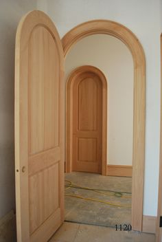 an empty room with two wooden doors in it