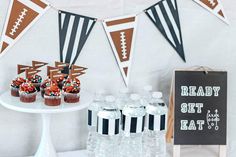 a football themed party with cupcakes and water bottles