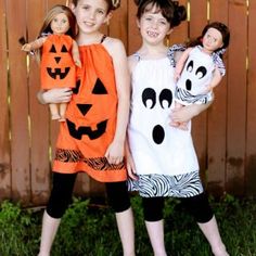 two girls in halloween costumes standing next to each other