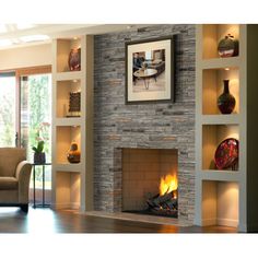 a living room filled with furniture and a fire place in front of a wall mounted fireplace