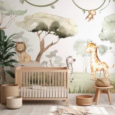 a baby's room with jungle animals and trees on the wall