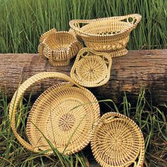 several woven baskets sitting on top of a log