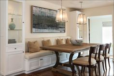 a dining room table with chairs and benches