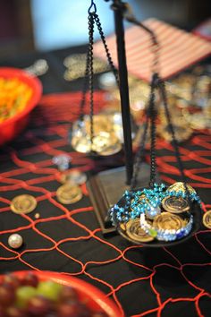 a table topped with lots of different types of jewelry on top of plates and bowls