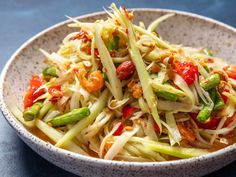 a white bowl filled with vegetables on top of a table